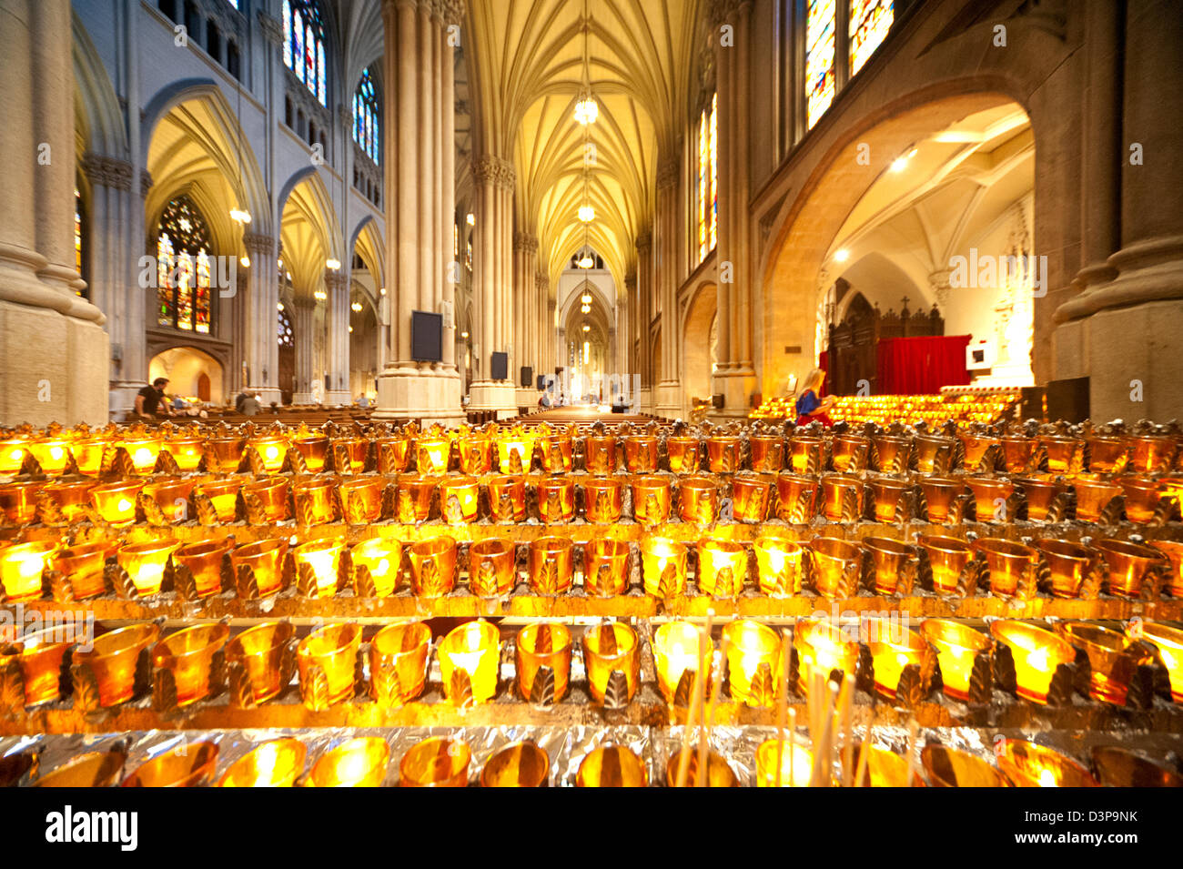 Candles light up the stunning ornate interior of the neo-gothic St Patrick's Cathedral in New York City. Stock Photo