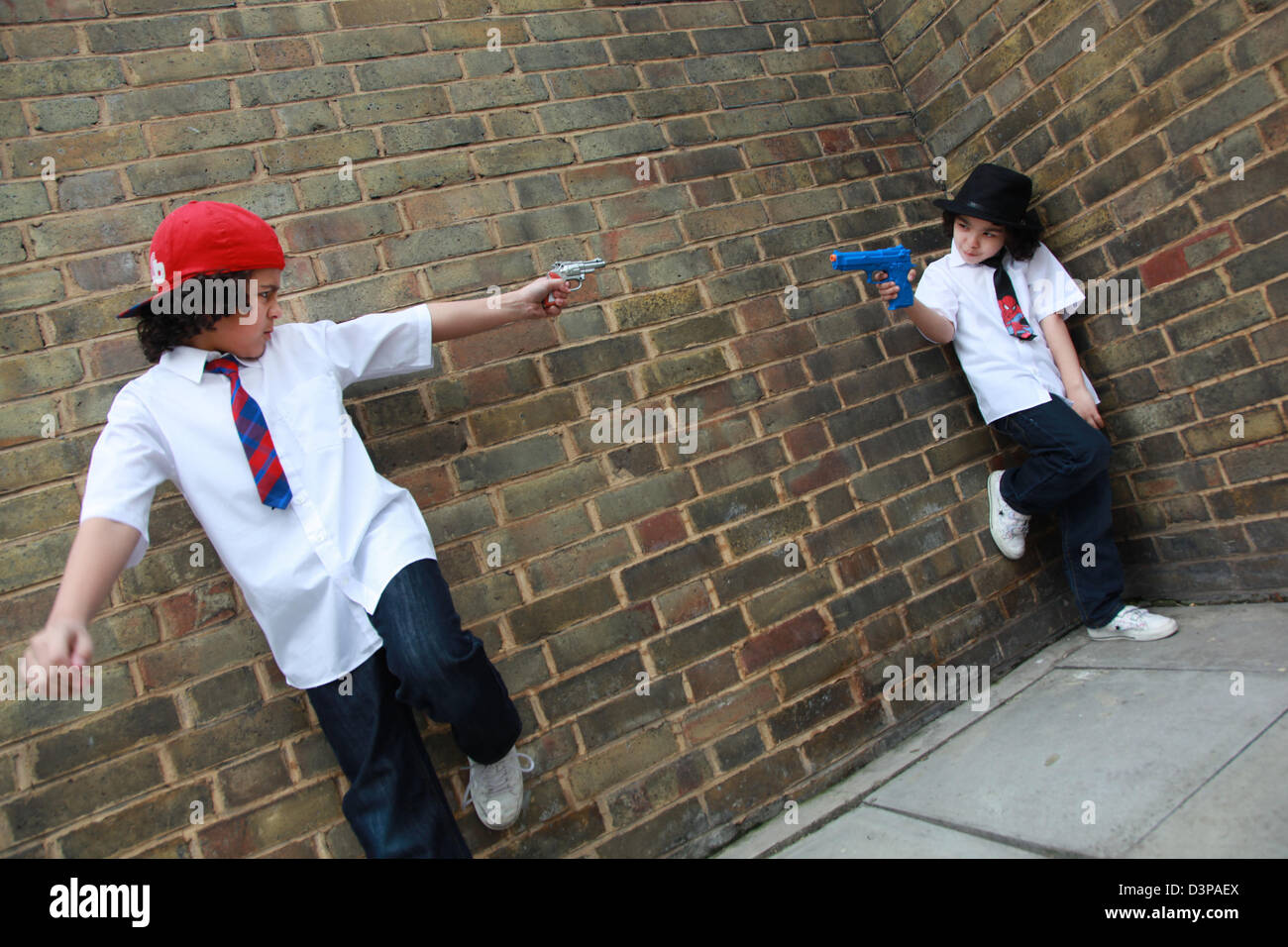 Boys play fighting with toy guns Stock Photo