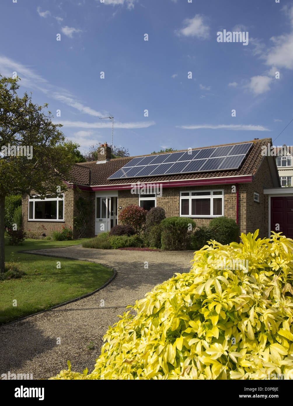 array of 16 solar panels on bungalow Stock Photo