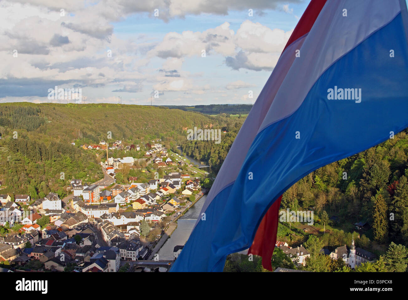 View from a window in Vianden Castle, Luxembourg over the town of Vianden and the River Our, and the Luxembourg flag. Stock Photo