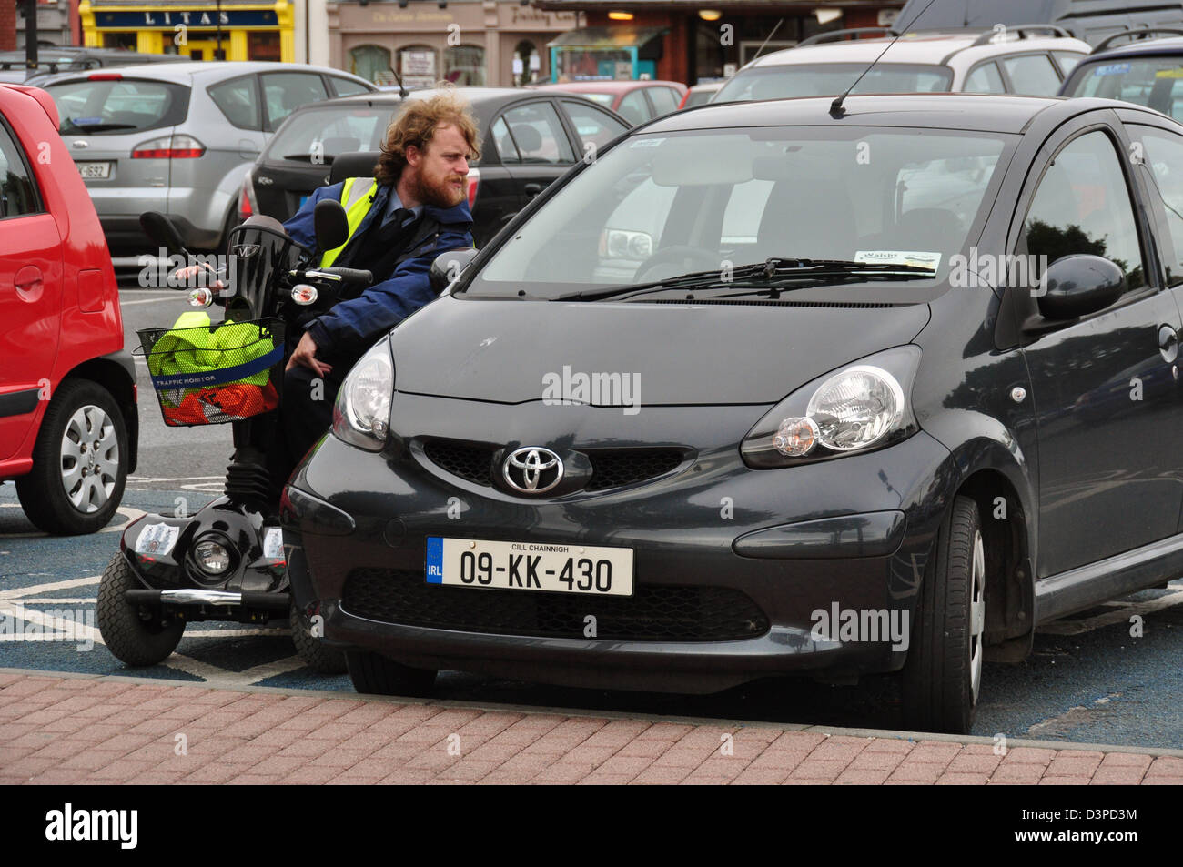 A disabled traffic warden at work in kilkenny ireland Stock Photo