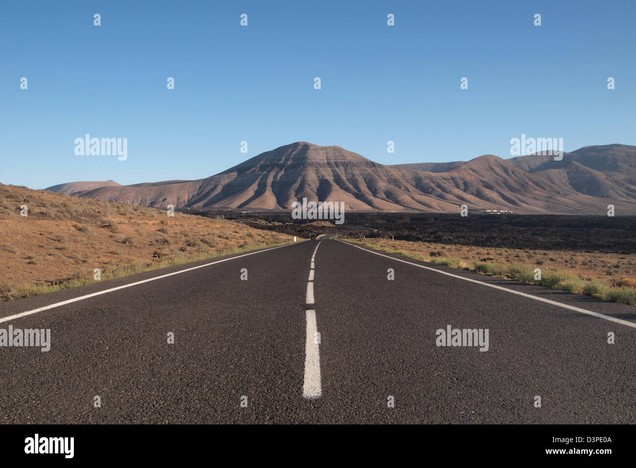 road through lava fields in timanfaya national park, lanzarote spain ...