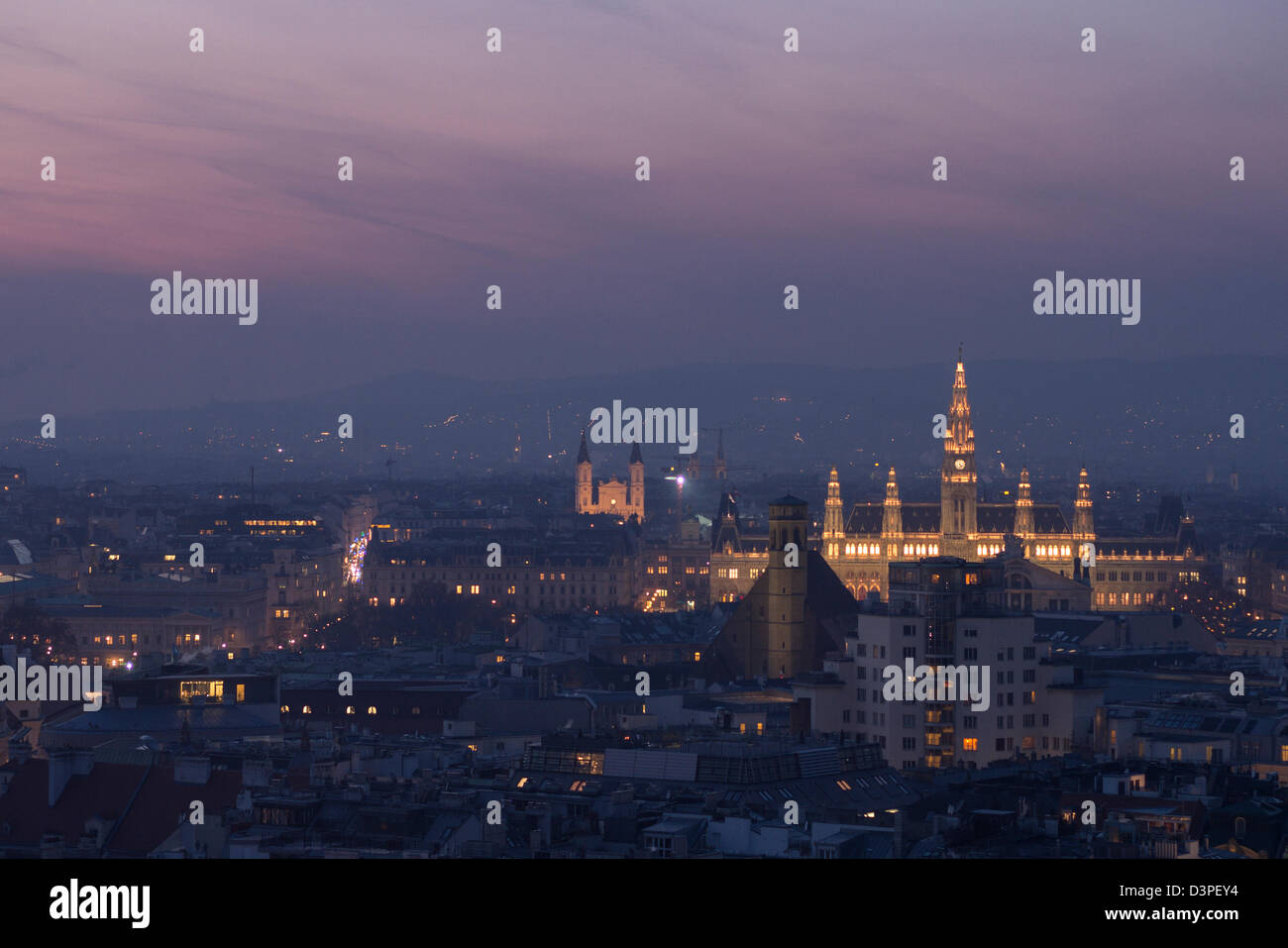 Vienna Cityscape: Rathaus at sunset. The view from the top of the Stephandom steeple. Including rathaus and the hills beyond. Stock Photo