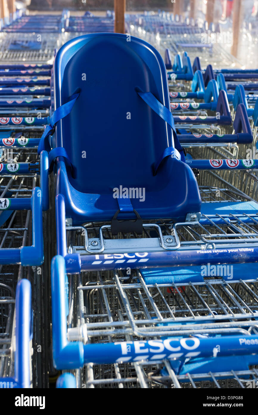 Tesco's shopping trolleys, one with baby seat attached. Montrose Scotland  Stock Photo - Alamy