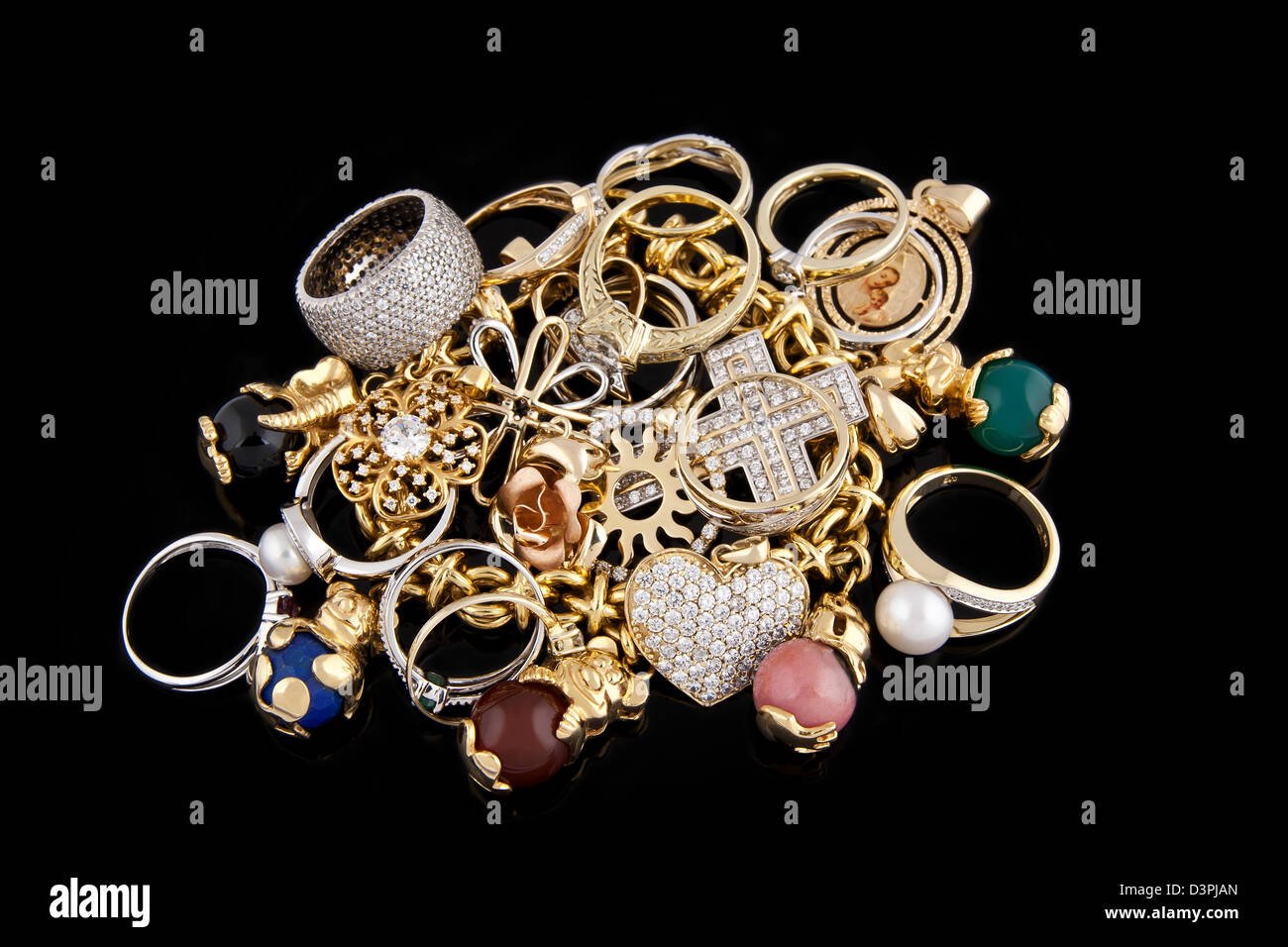 Gold jewelry on a black background Stock Photo Alamy