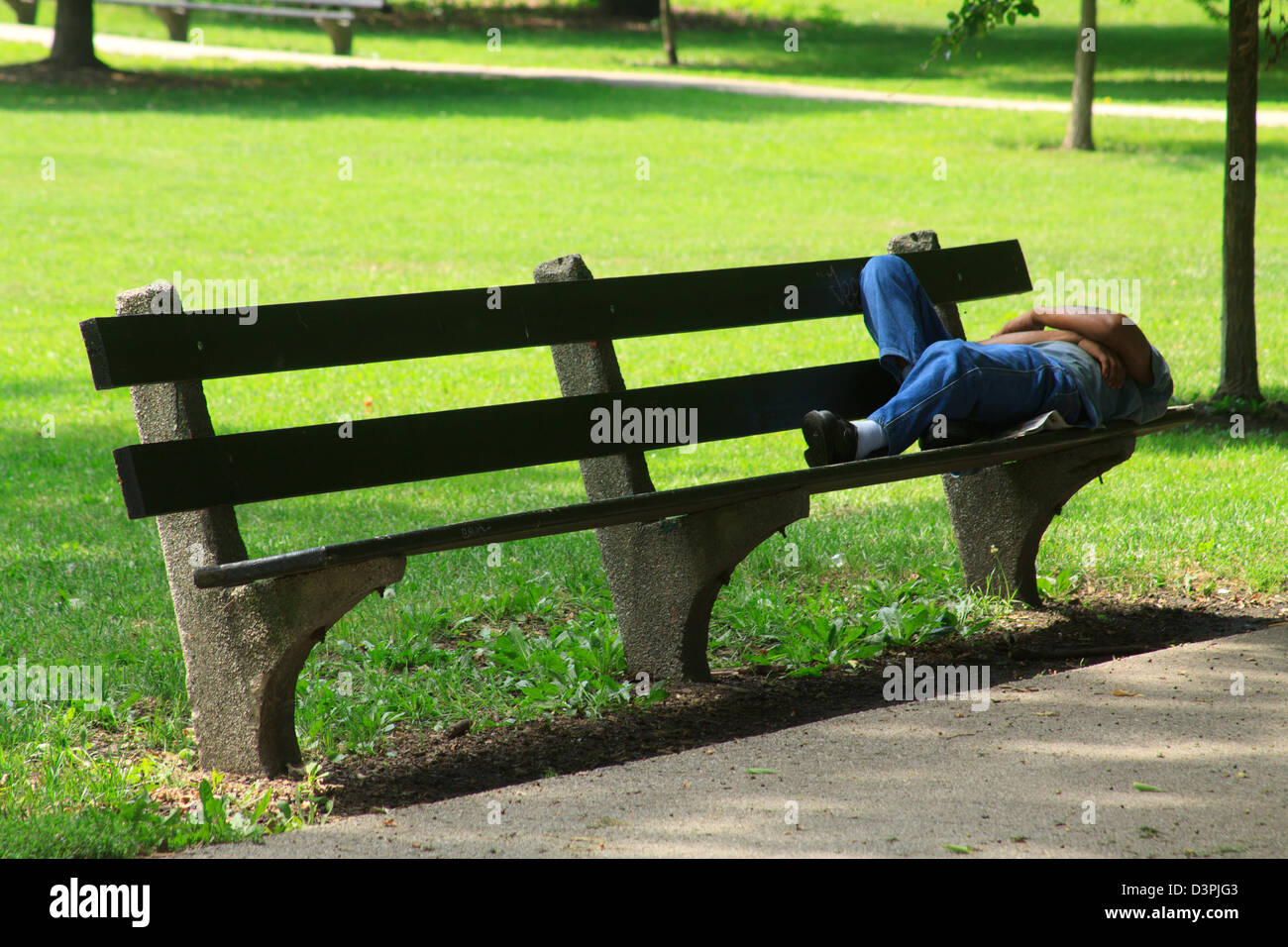 Man sleeping on a bench Stock Photo