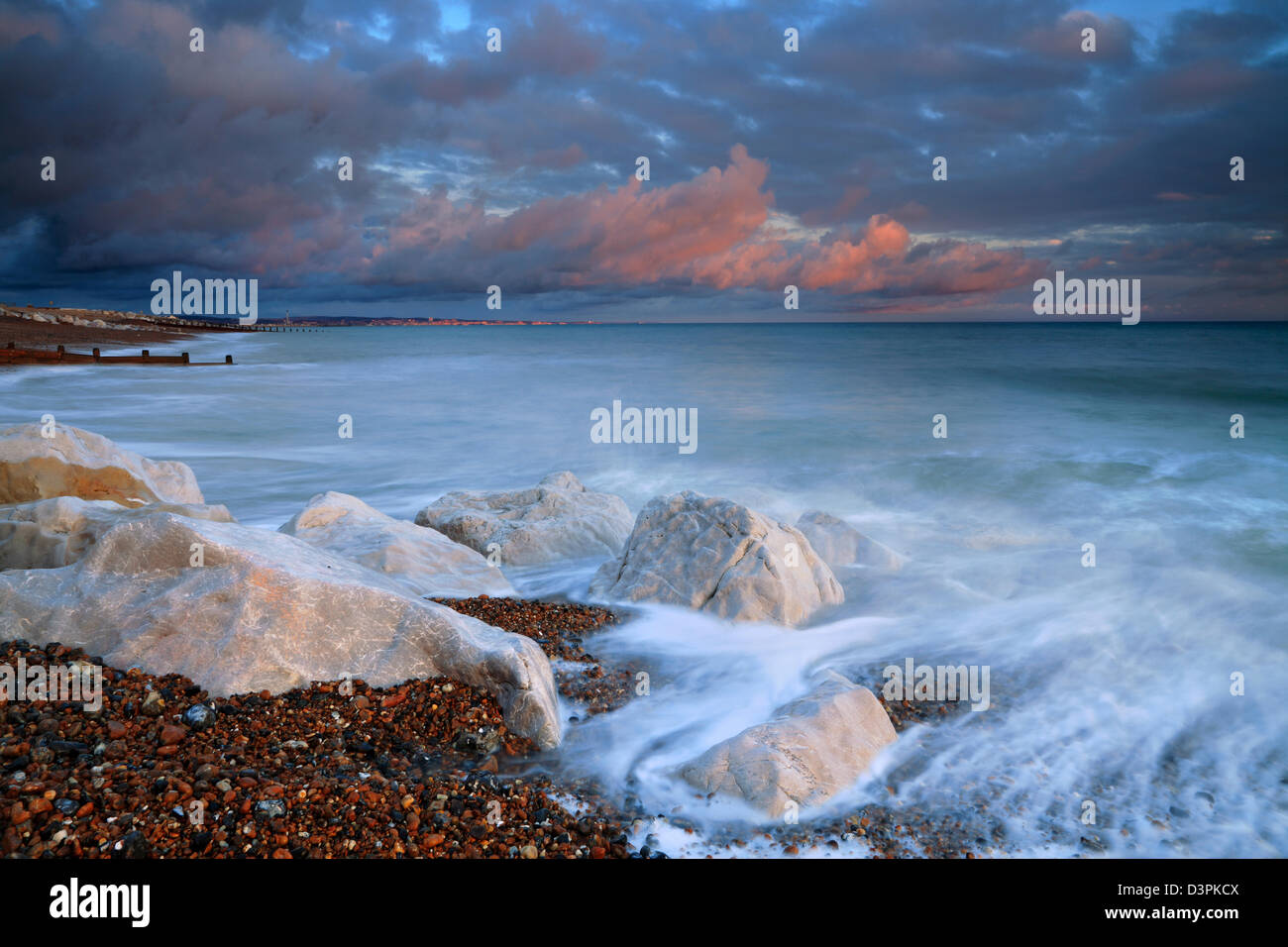 Twilight reflections and tidal waves, Lancing coast, West Sussex Stock Photo