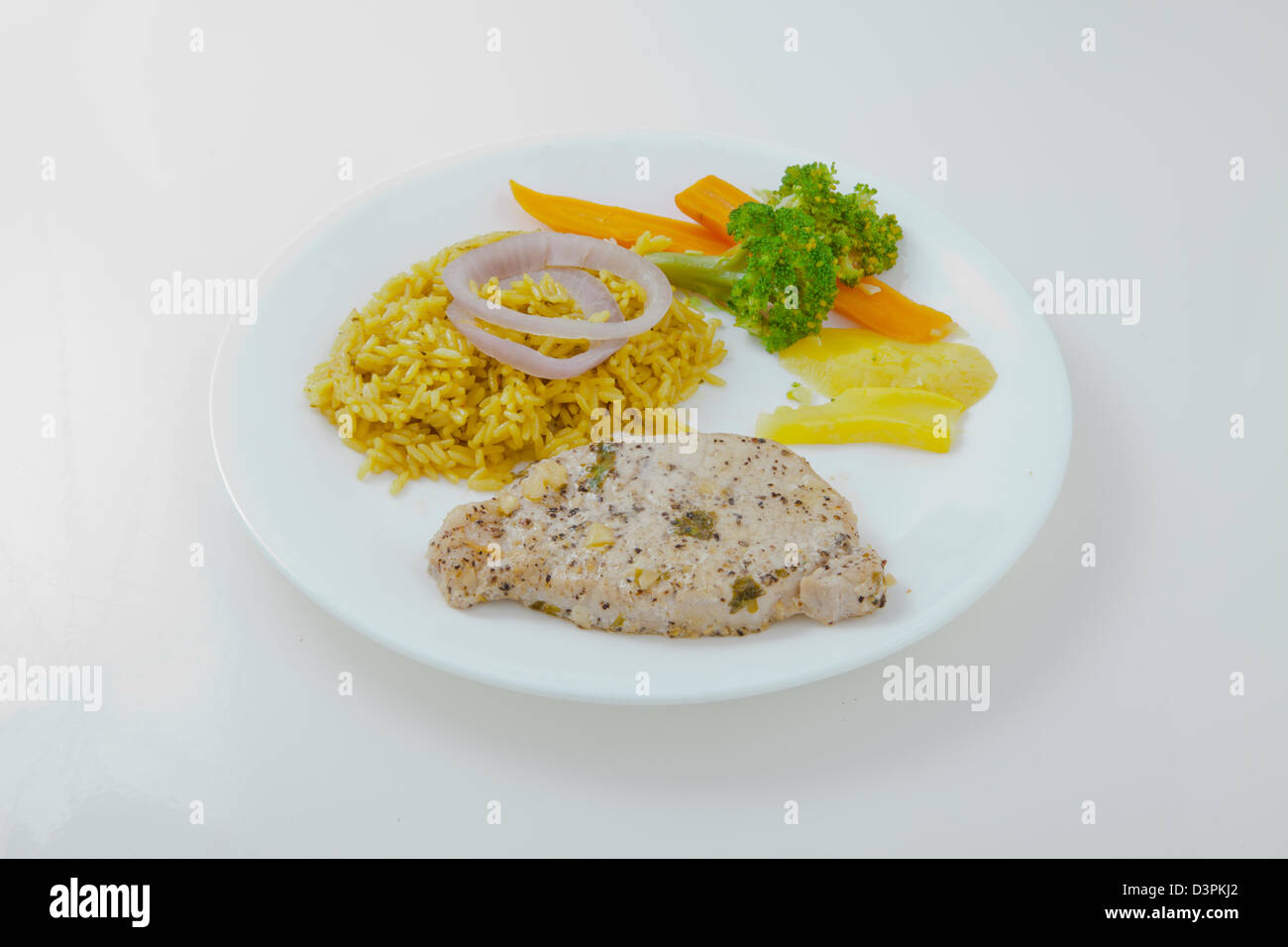 Pork chops yellow rice and vegetables Stock Photo Alamy