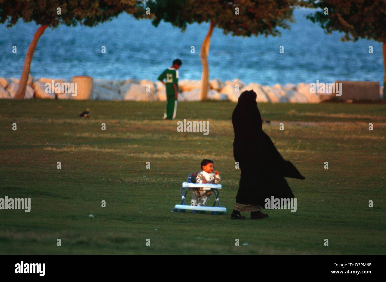 A Saudi woman with baby in stroller at a park in al khobar, saudi