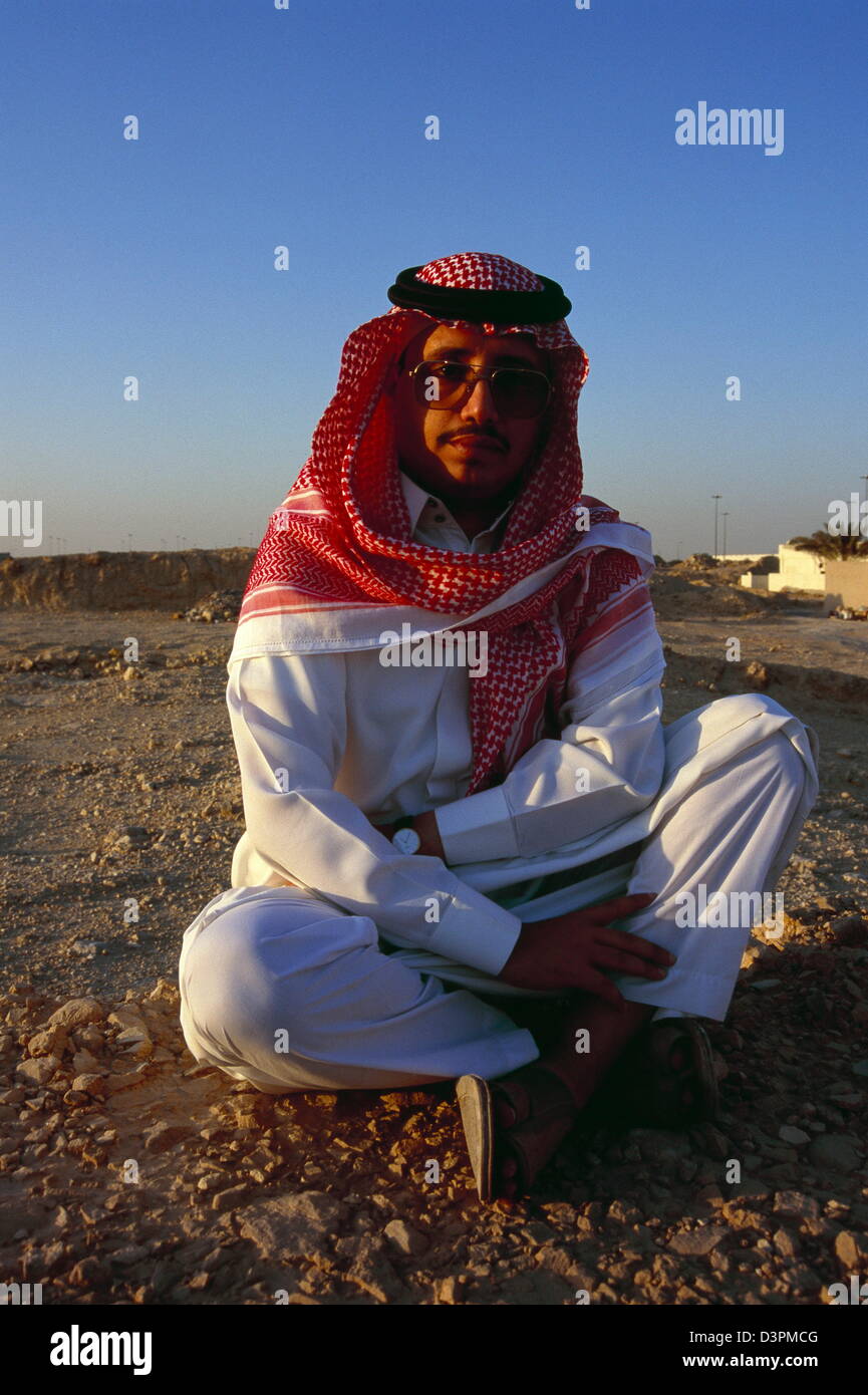 A Saudi rests in the desert on the outskirts of Jeddah, by the red sea. Stock Photo
