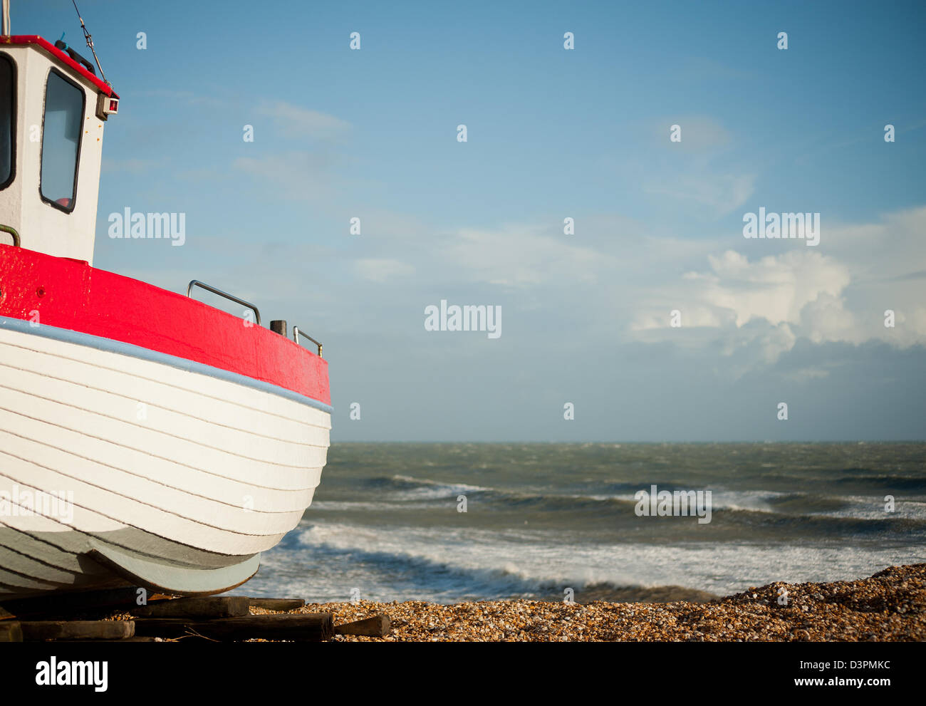 Small wooden fishing boat on the shingle beach at Dungeness in Kent, UK ...