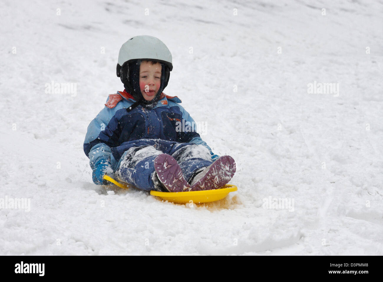 Leipzig, Germany, a young boy sledging on the wart called Rodelberg Stock Photo