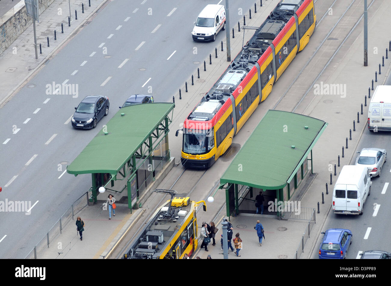 Yellow tram at Aleje Jerozolimskie (literally Jerusalem Avenues) - one of the main and longest street in Warsaw, Poland Stock Photo