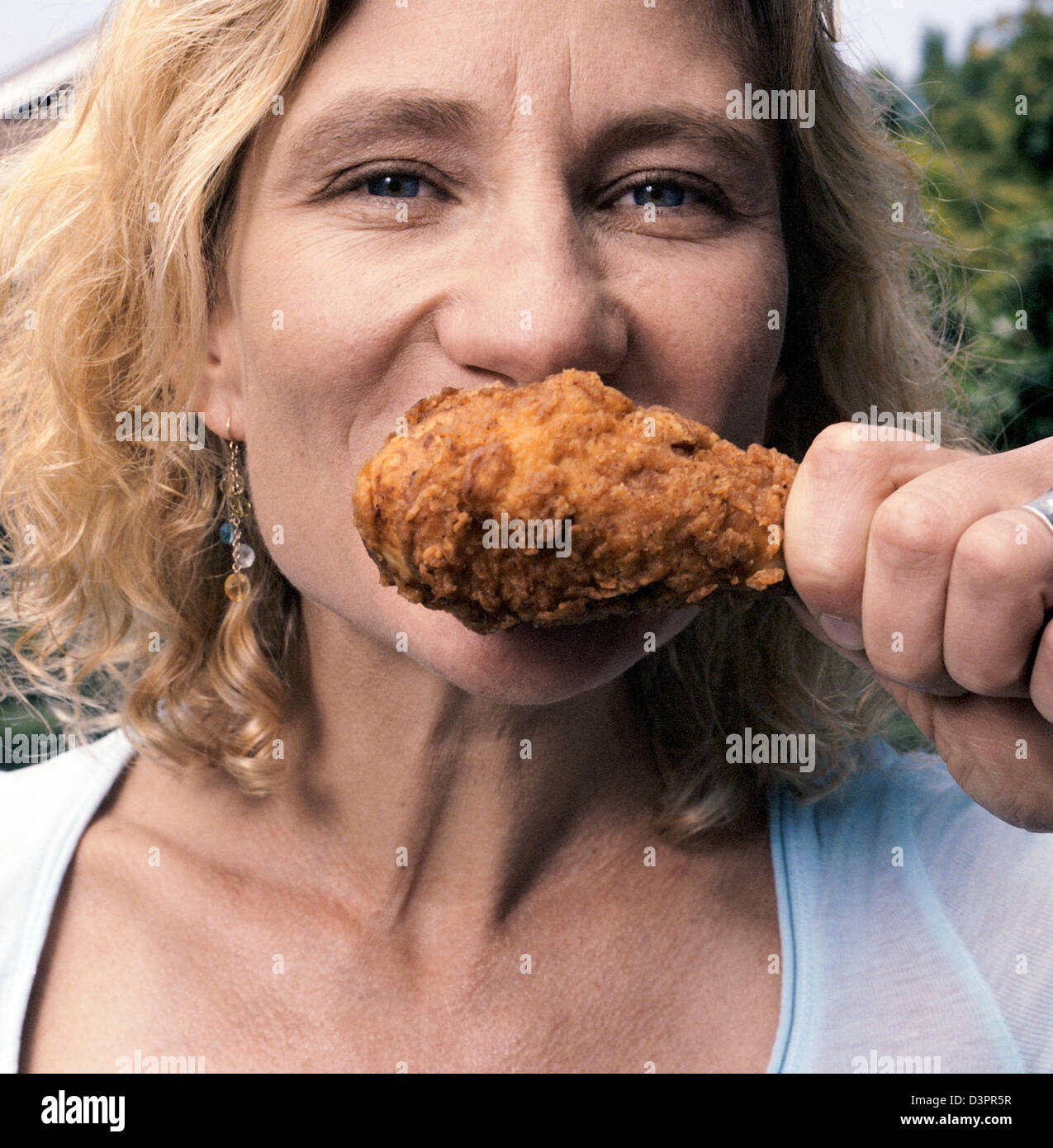 Woman eating chicken drumstick hires stock photography and images Alamy