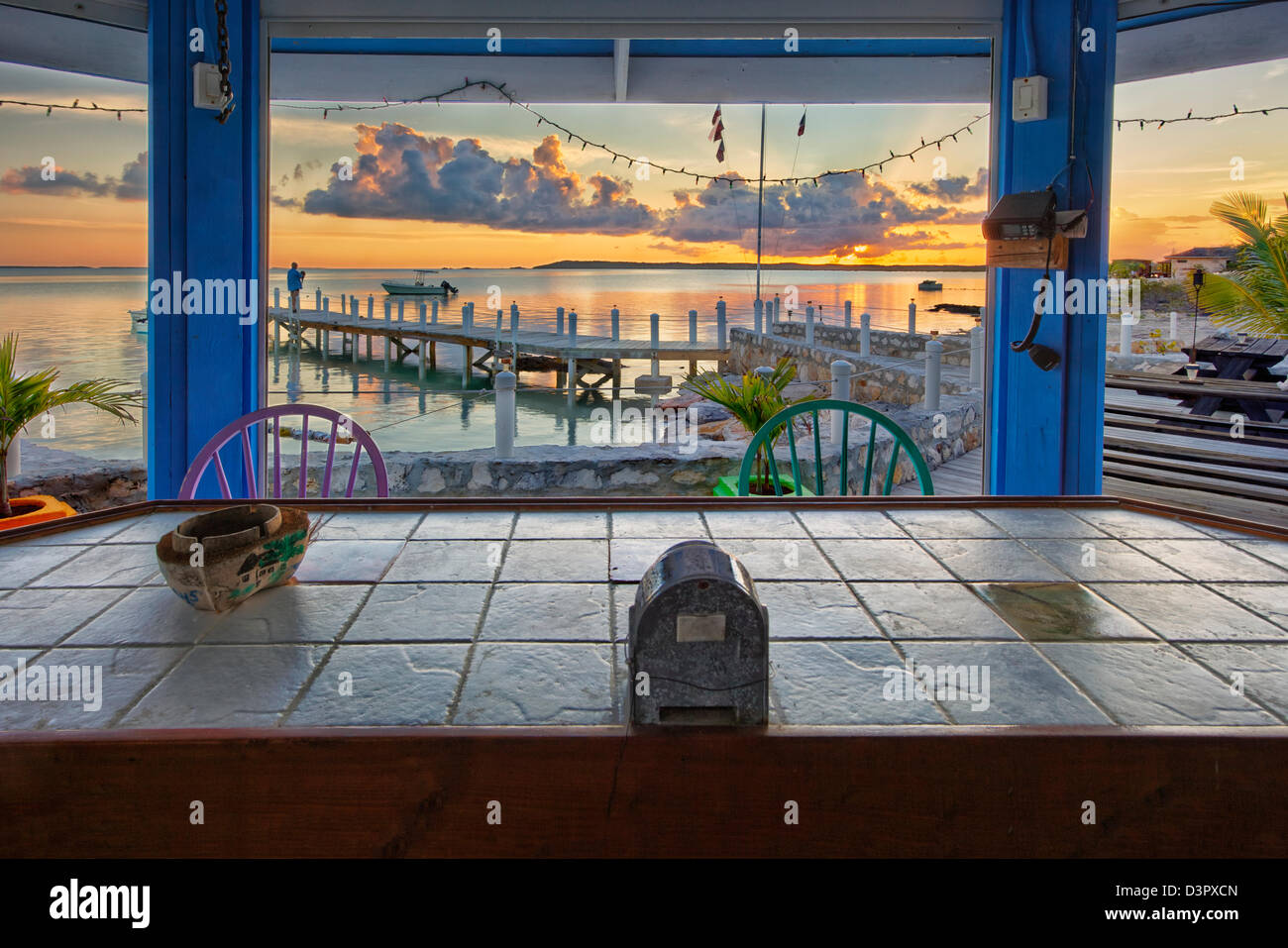 Relax at a beach side bar and enjoy the beautiful sunsets on Exuma Island, Bahamas Stock Photo