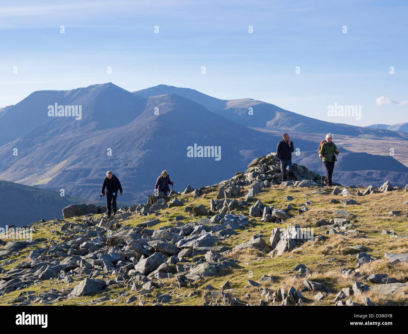 Hikers hiking ascending Moel Faban mountain in mountains of Snowdonia National Park above Bethesda, Gwynedd, North Wales, UK, Britain Stock Photo