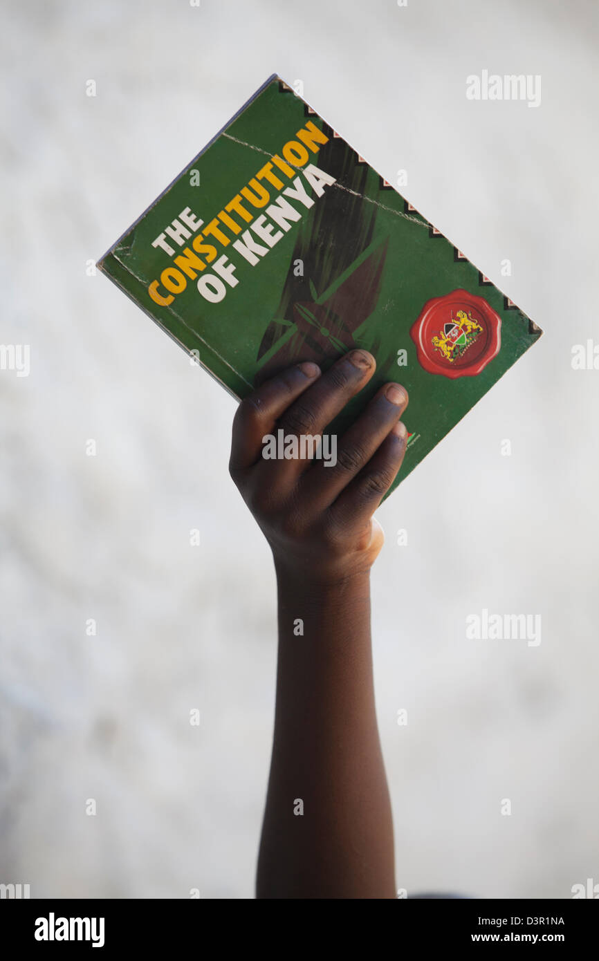 Hand holding a copy of 'The Constitution of Kenya', February 2013. Stock Photo