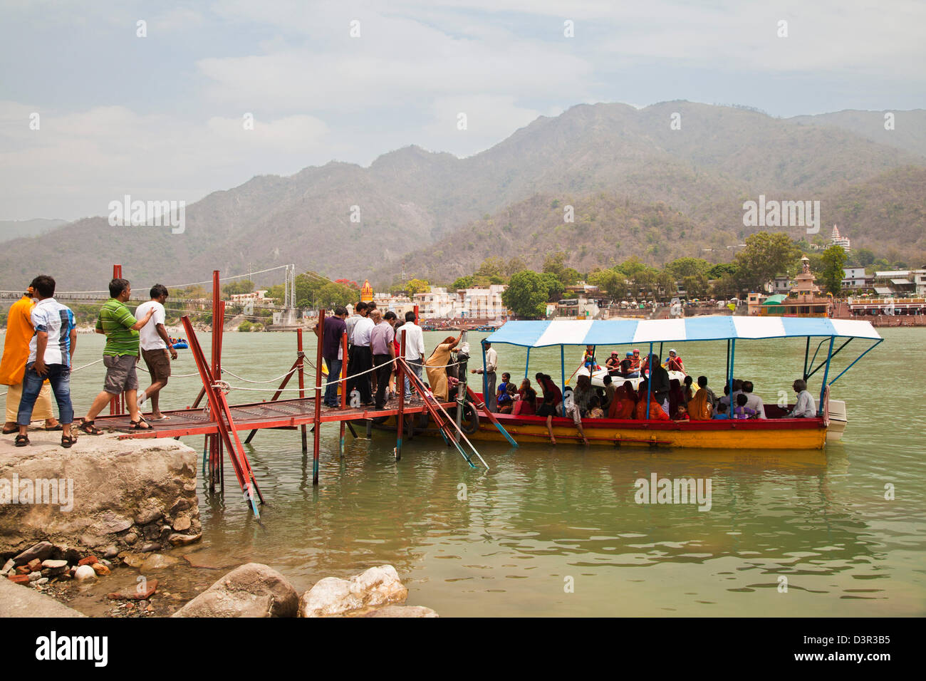 People boarding a boat at Ganges River, Ram Jhula, Rishikesh, Uttarakhand, India Stock Photo
