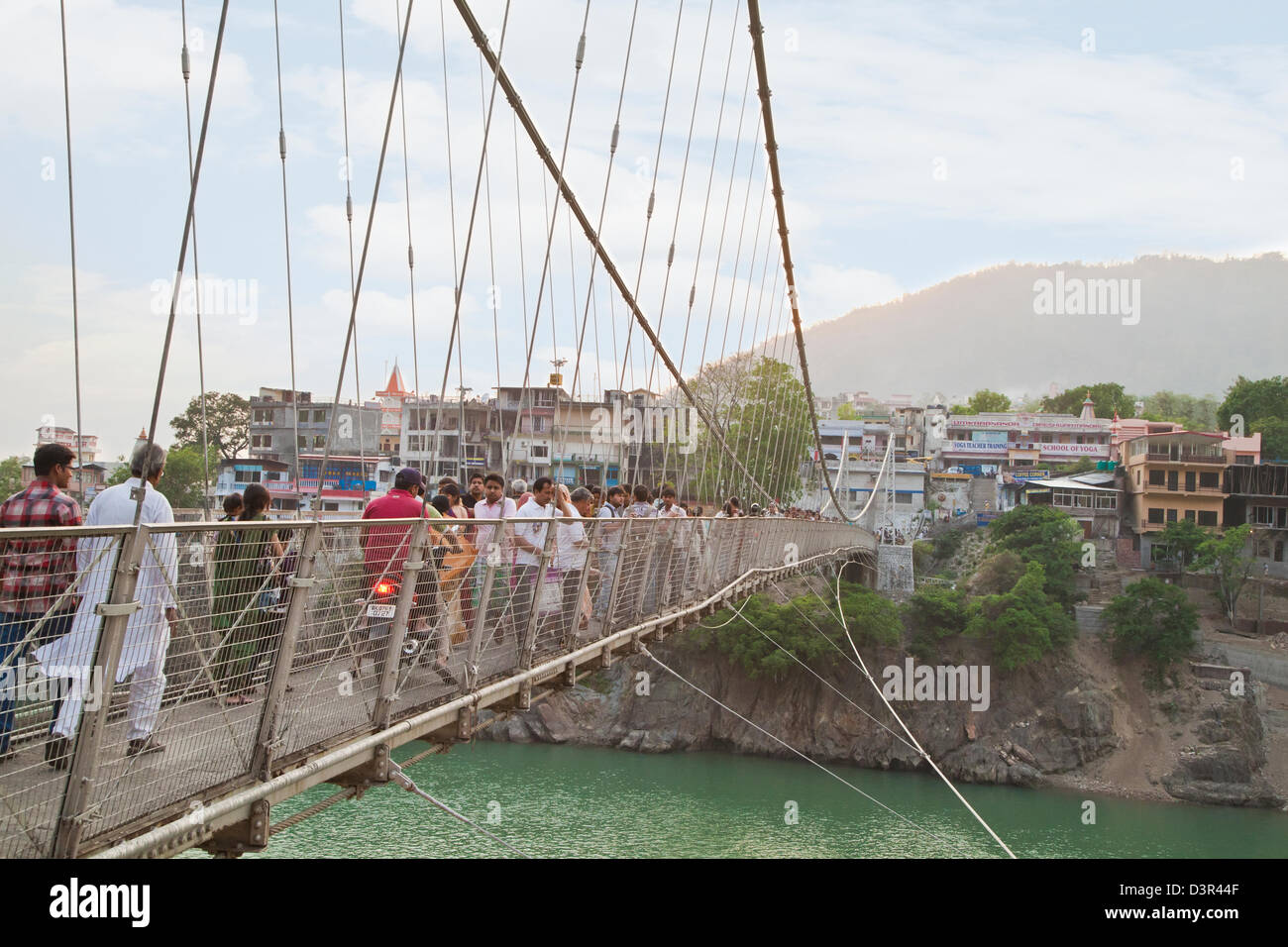 Tourists standing on a suspension bridge, Lakshman Jhula, River Ganges
