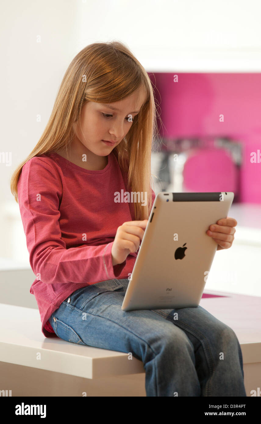 Young girl playing on an apple iPad tablet computer Stock Photo