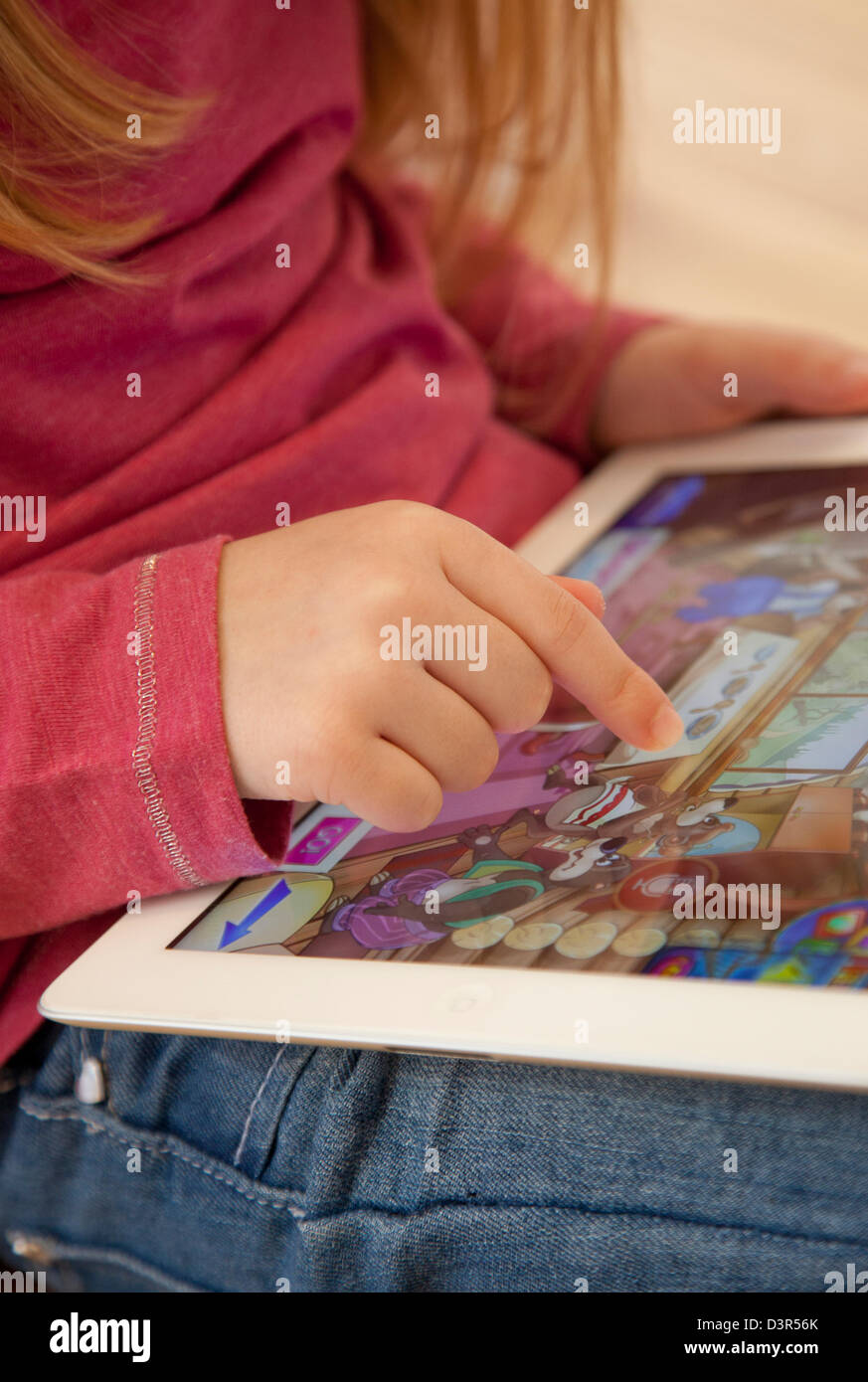 Young girl playing on an apple iPad tablet computer Stock Photo