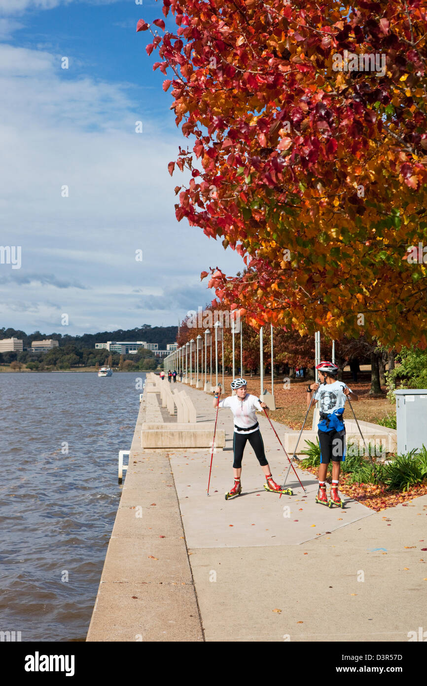 Teenagers crosss-country roller skiing around Lake Burley Griffin.  Canberra, Australian Capital Territory (ACT), Australia Stock Photo