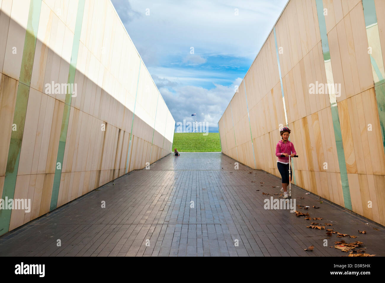 Kids playing in marble-lined walkway at Commonwealth Place. Canberra, Australian Capital Territory (ACT), Australia Stock Photo