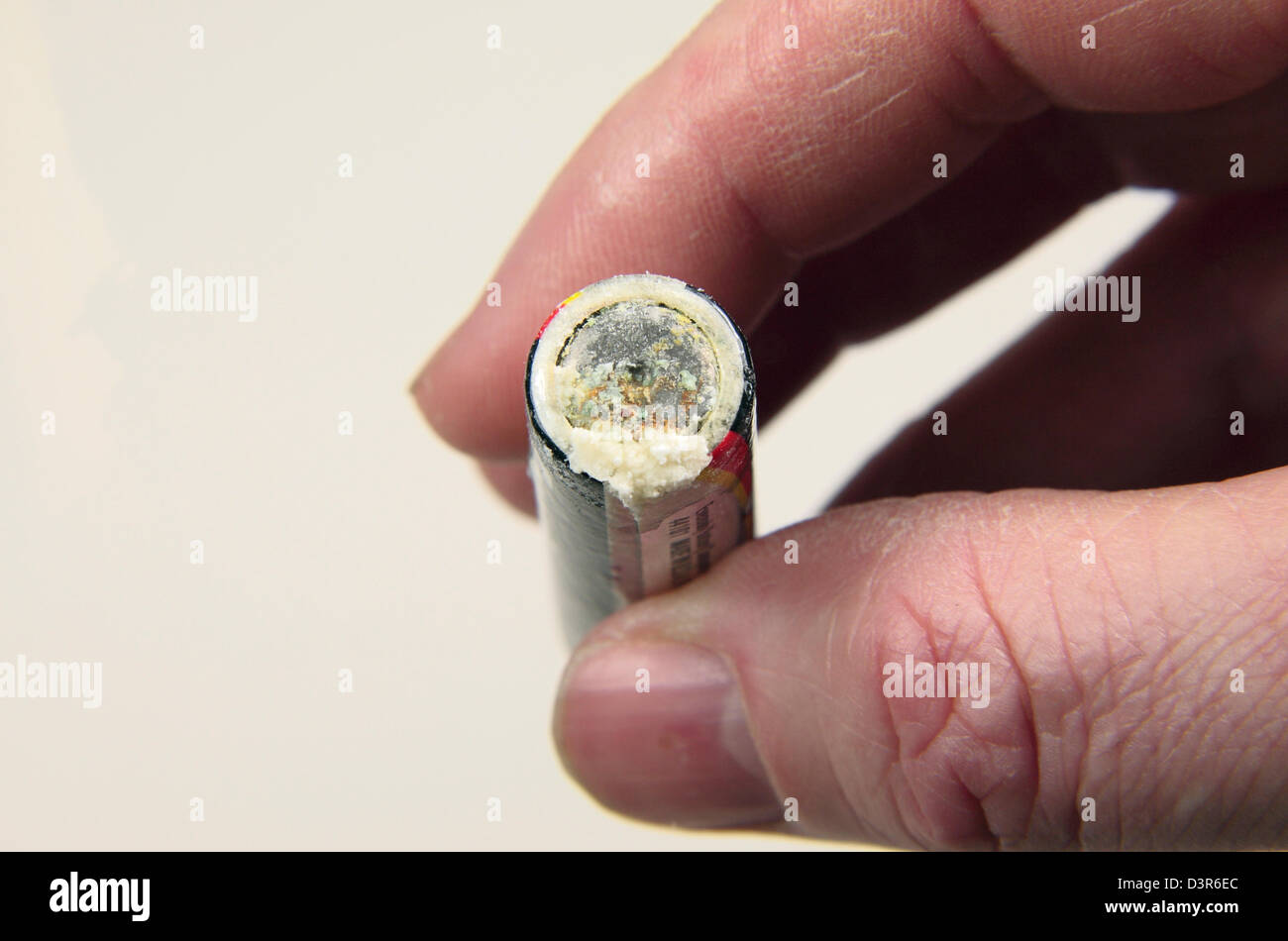 A leaking/corroded 1.5V AA battery (as used in the UK). Stock Photo