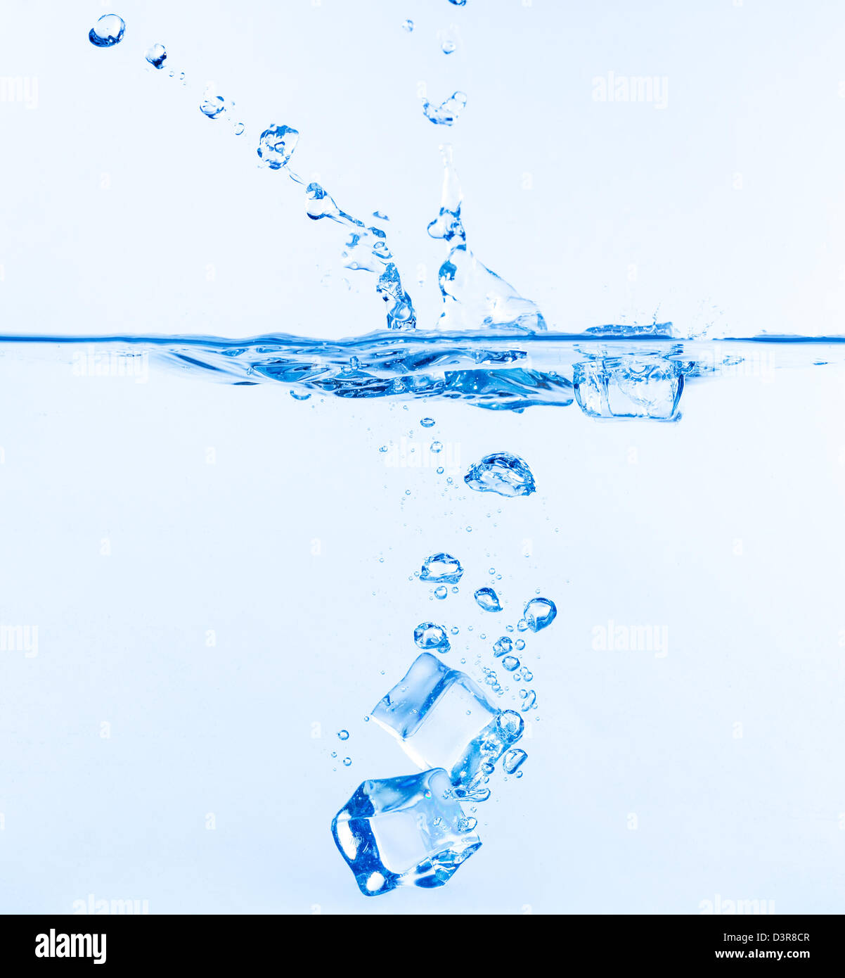 Ice Cubes Dropped into Water with Splash on white Stock Photo - Alamy