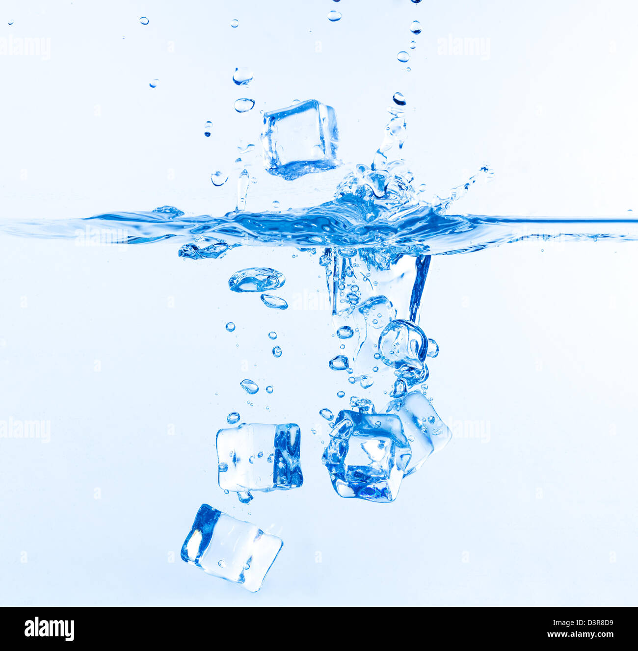 Ice Cubes Dropped into Water with Splash on white Stock Photo - Alamy