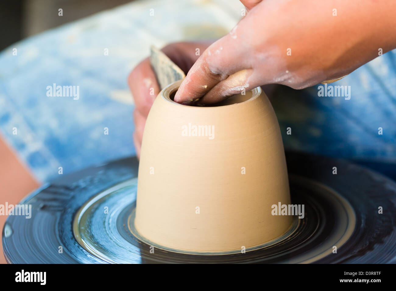 Potter master creating a bowl on a Potter's wheel Stock Photo - Alamy
