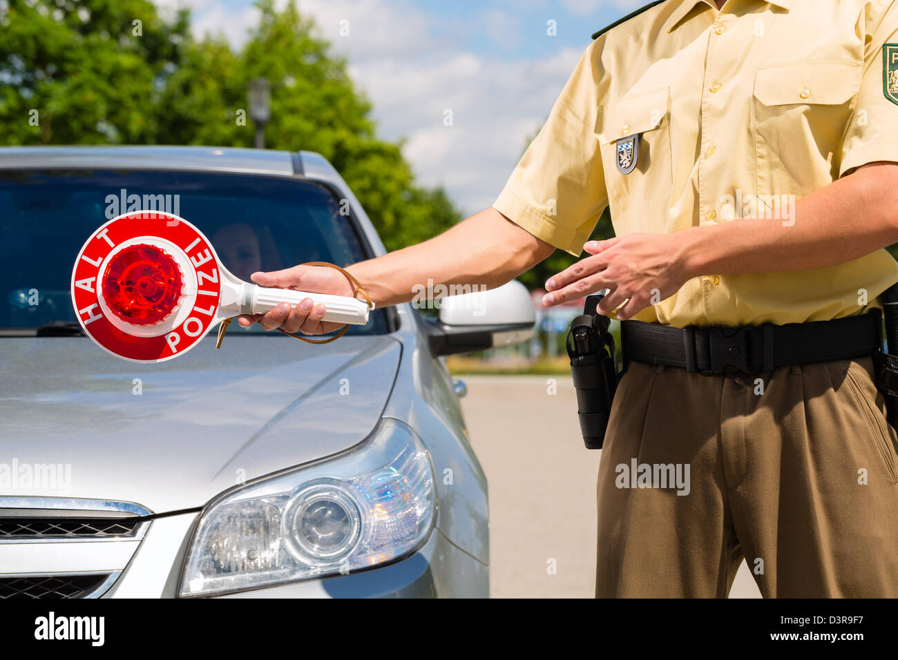 Police - policeman or cop in uniform stop car in traffic control Stock Photo