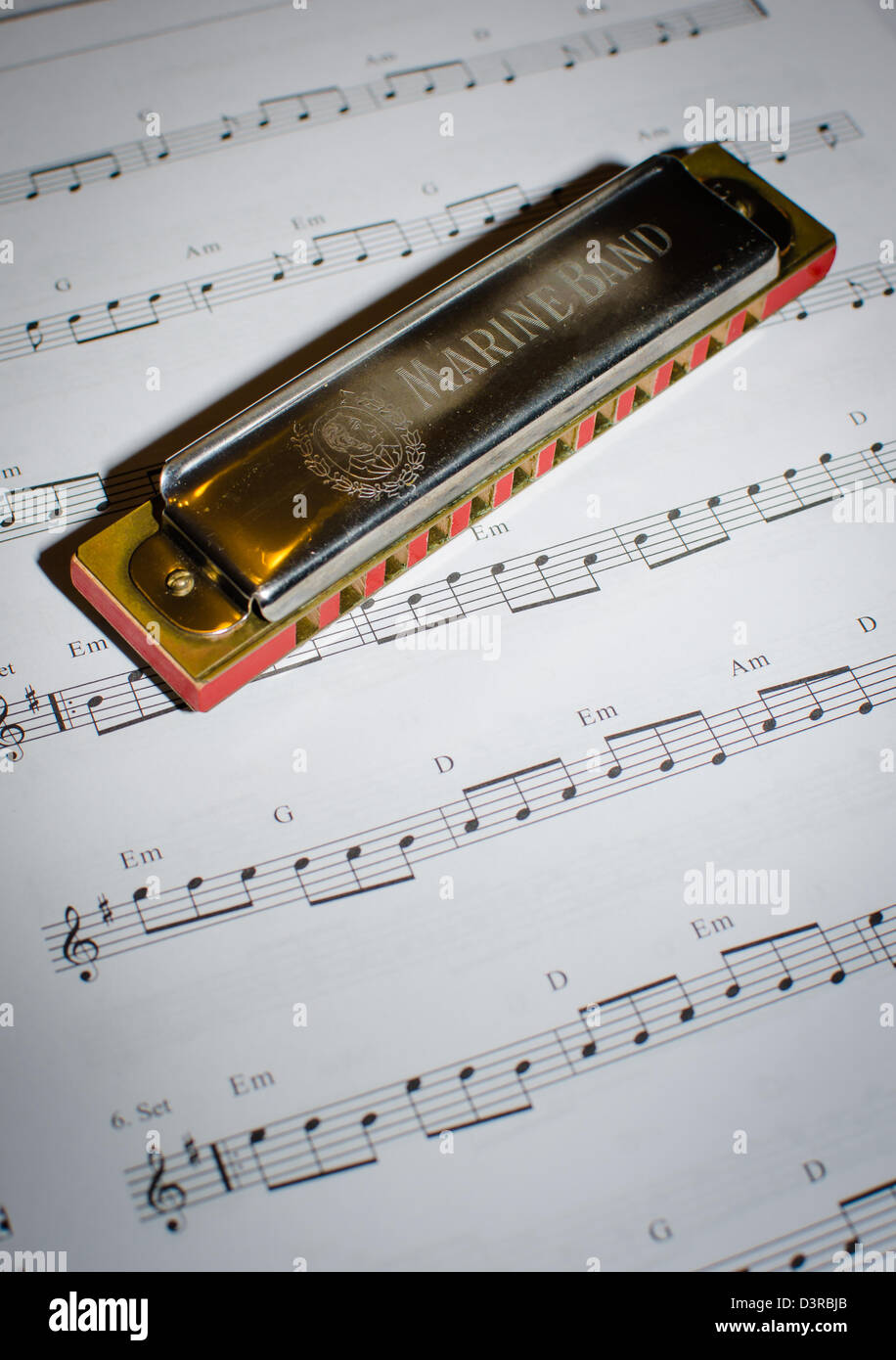 Old Harmonica And Note Sheet Stock Photo
