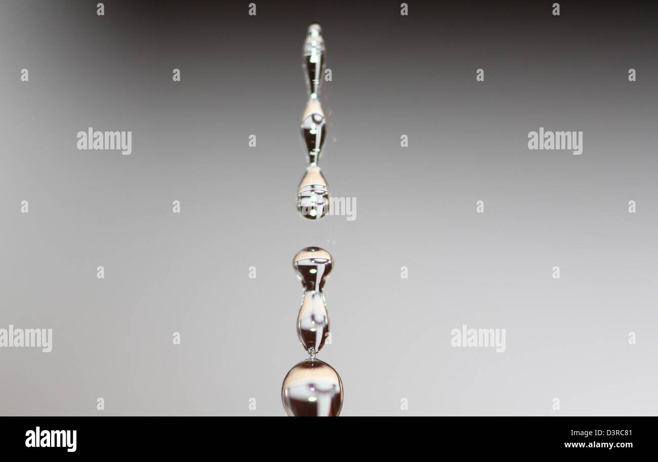 A single water drop splitting as it leaves a kitchen tap Stock Photo