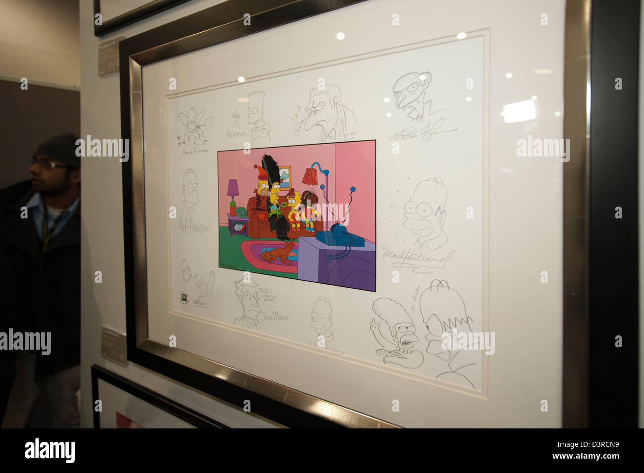 23rd February 2013, London, UK. The Super Comic Convention features comic creators, artists, publishers and retailers. Art You Grew Up With stand, selling original and limited edition cartoon and comic artwork. Feature work is framed and illustrated still from The Simpsons signed by the cast. Stock Photo