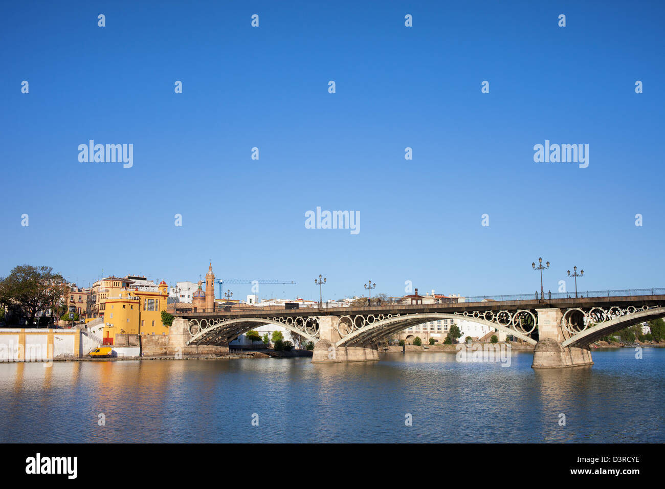 Triana Bridge (Isabel II Bridge) from 19th century on Guadalquivir river in the city of Seville, Andalusia, Spain. Stock Photo