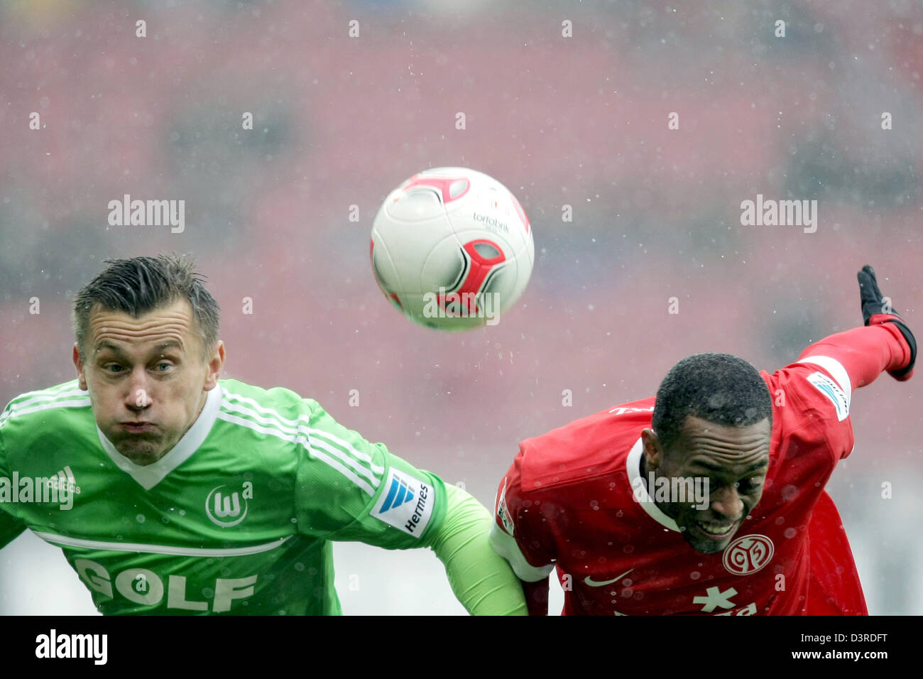 Mainz's Junior Diaz (R) and Wolfsburg's Ivica Olic vie for the ball during the Bundesliga soccer match between FSV Mainz 05 and VfL Wolfsburg at Coface Arena in Mainz, Germany, 23 February 2013. The match ended 1-1 undecided. Photo: FREDRIK VON ERICHSEN  (ATTENTION: EMBARGO CONDITIONS! The DFL permits the further  utilisation of up to 15 pictures only (no sequntial pictures or video-similar series of pictures allowed) via the internet and online media during the match (including halftime), taken from inside the stadium and/or prior to the start of the match. The DFL permits the unrestricted tr Stock Photo
