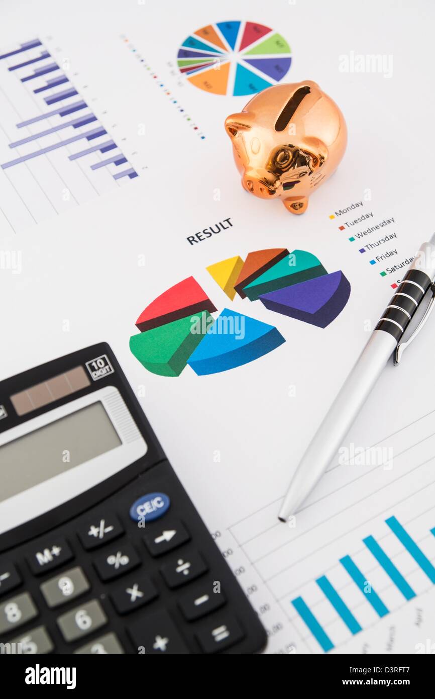 Money savings concept: charts, calculator, pen, pig Stock Photo