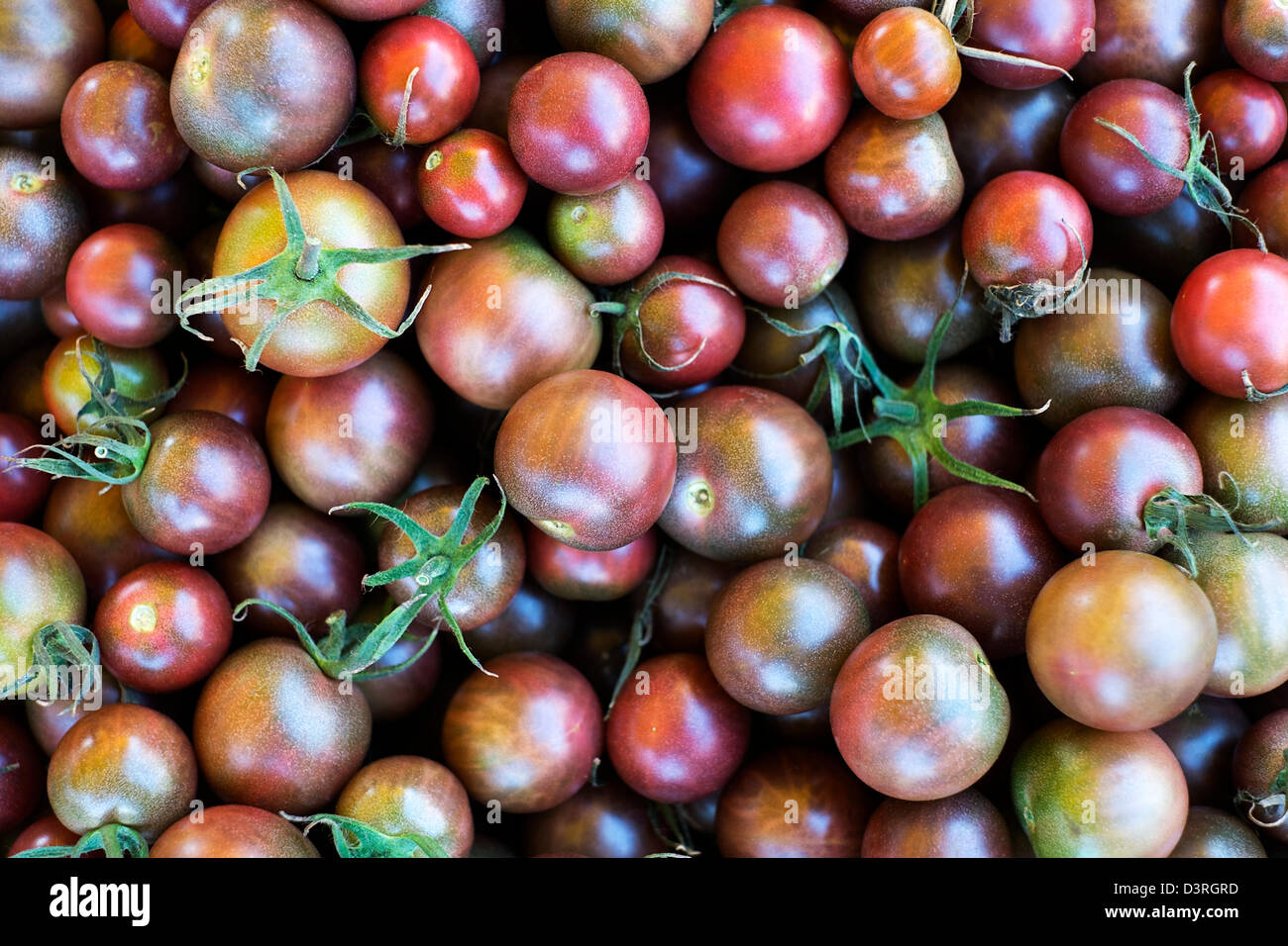 Black cherry tomatoes on a farmer's market Stock Photo - Alamy