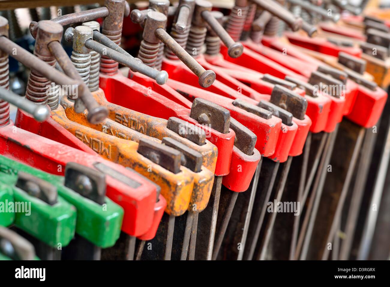 Some colored iron tools in a factory Stock Photo Alamy