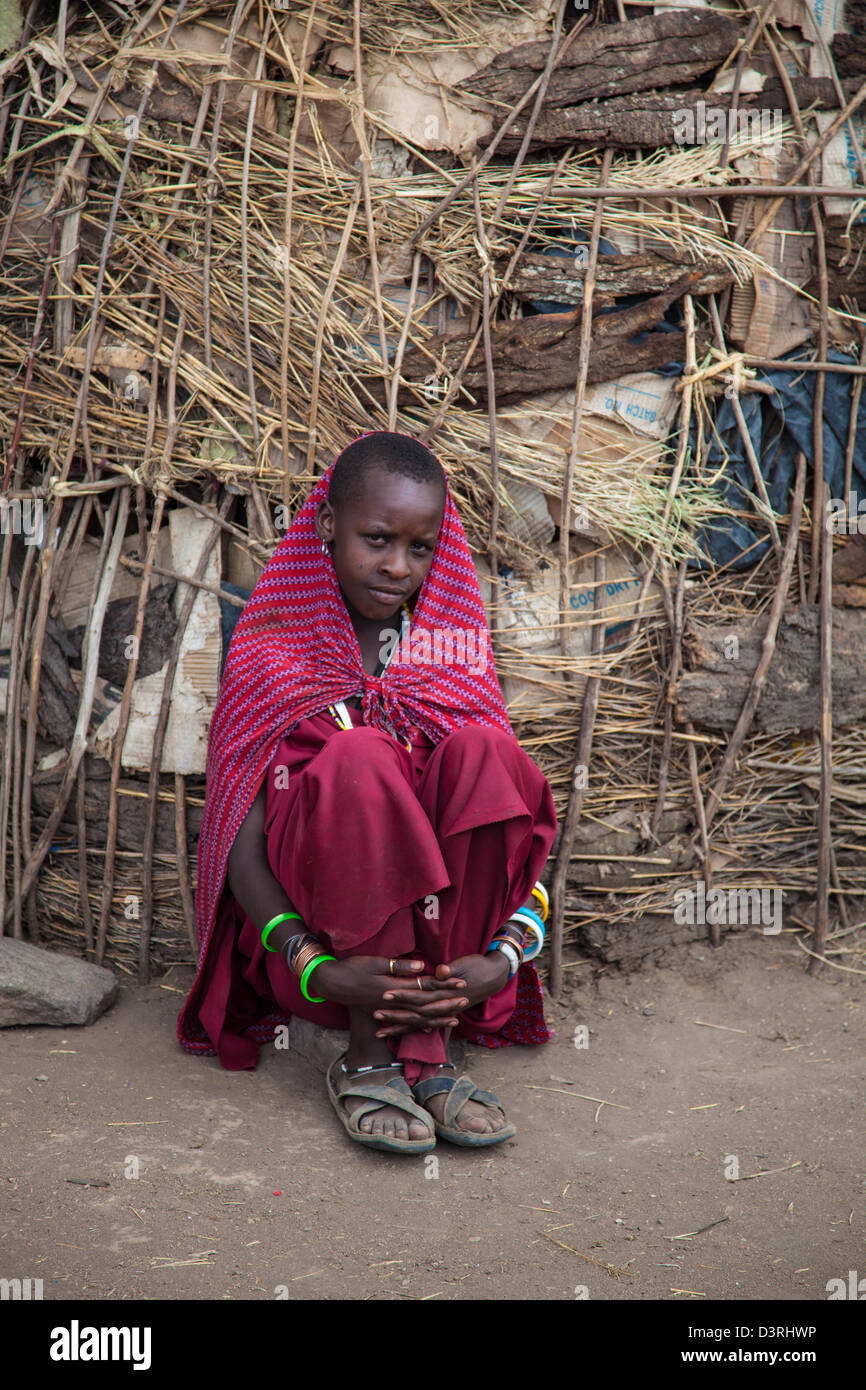 A masai girl looks bashfully into the camera. Serengeti National Park, Tanzania Stock Photo