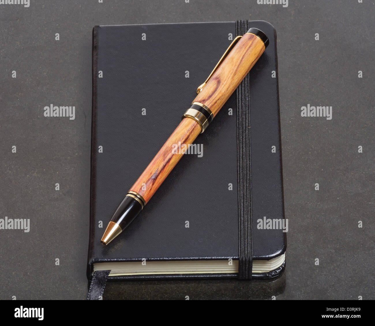 A black vintage notebook with an expensive pen Stock Photo