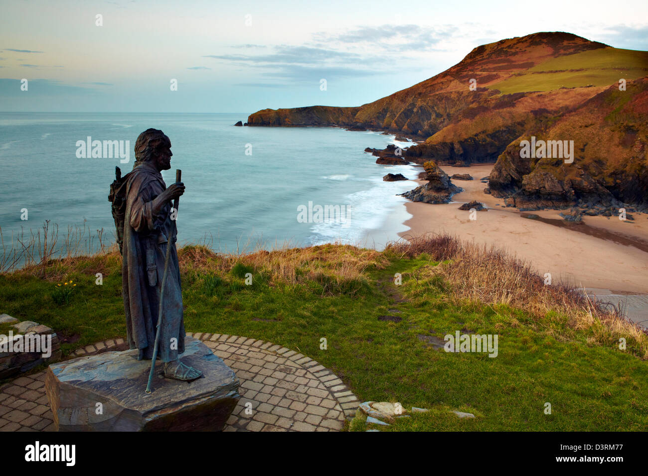 Statue of St Carannog  by artist Sebastien Boyesen overlooking Llangrannog beach, Ceredigion, West Wales. Stock Photo