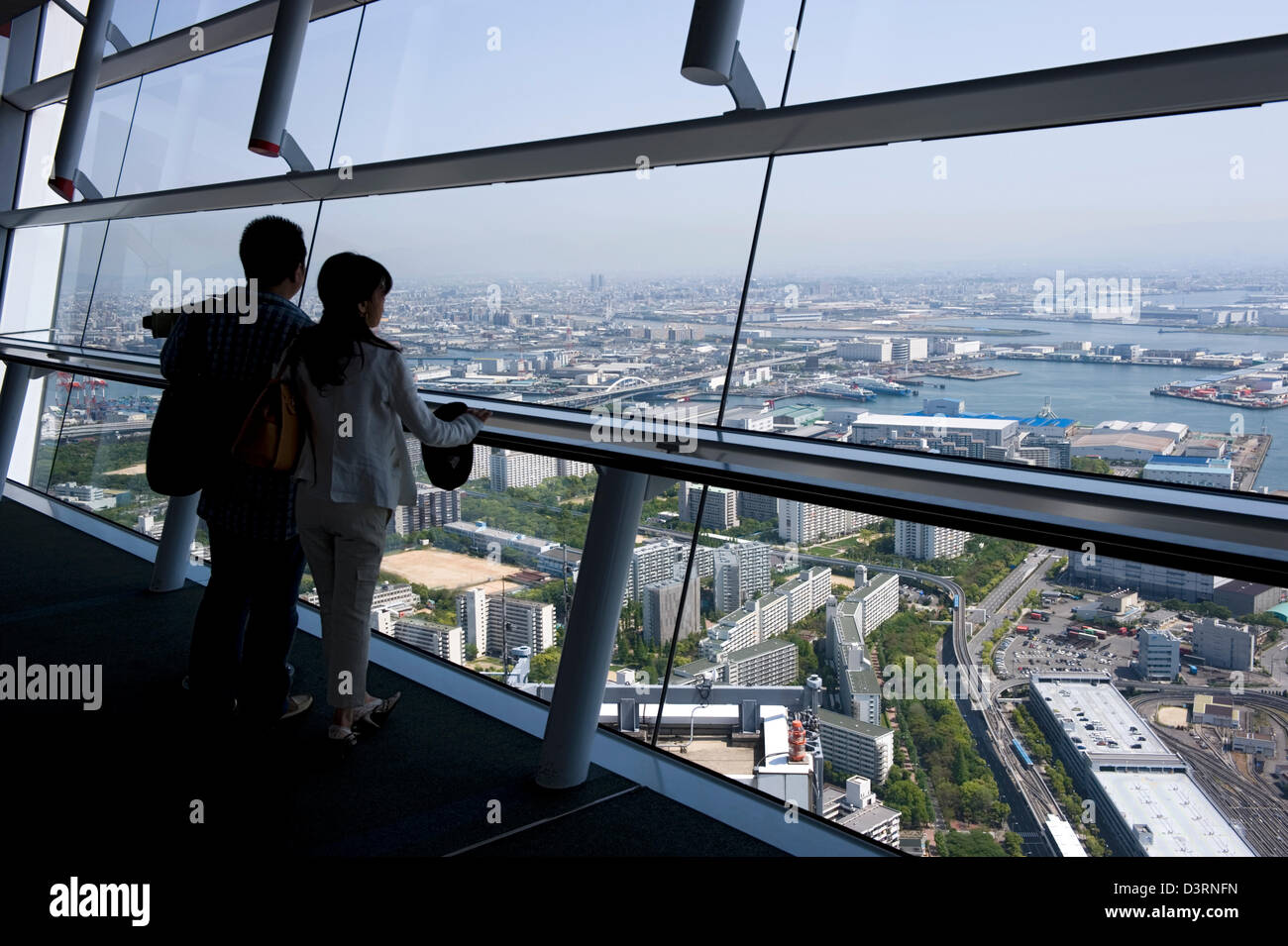 Visitors to observation deck of World Trade Center (WTC) Cosmo Tower on  Sakishima Nanko Island get aerial view of Osaka harbor Stock Photo - Alamy