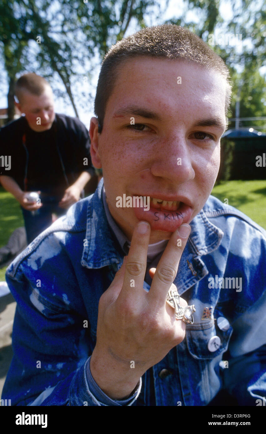 Oi!-The Meeting, a young man shows the word SKIN tattooed on his lip, Luebeck, Germany Stock Photo