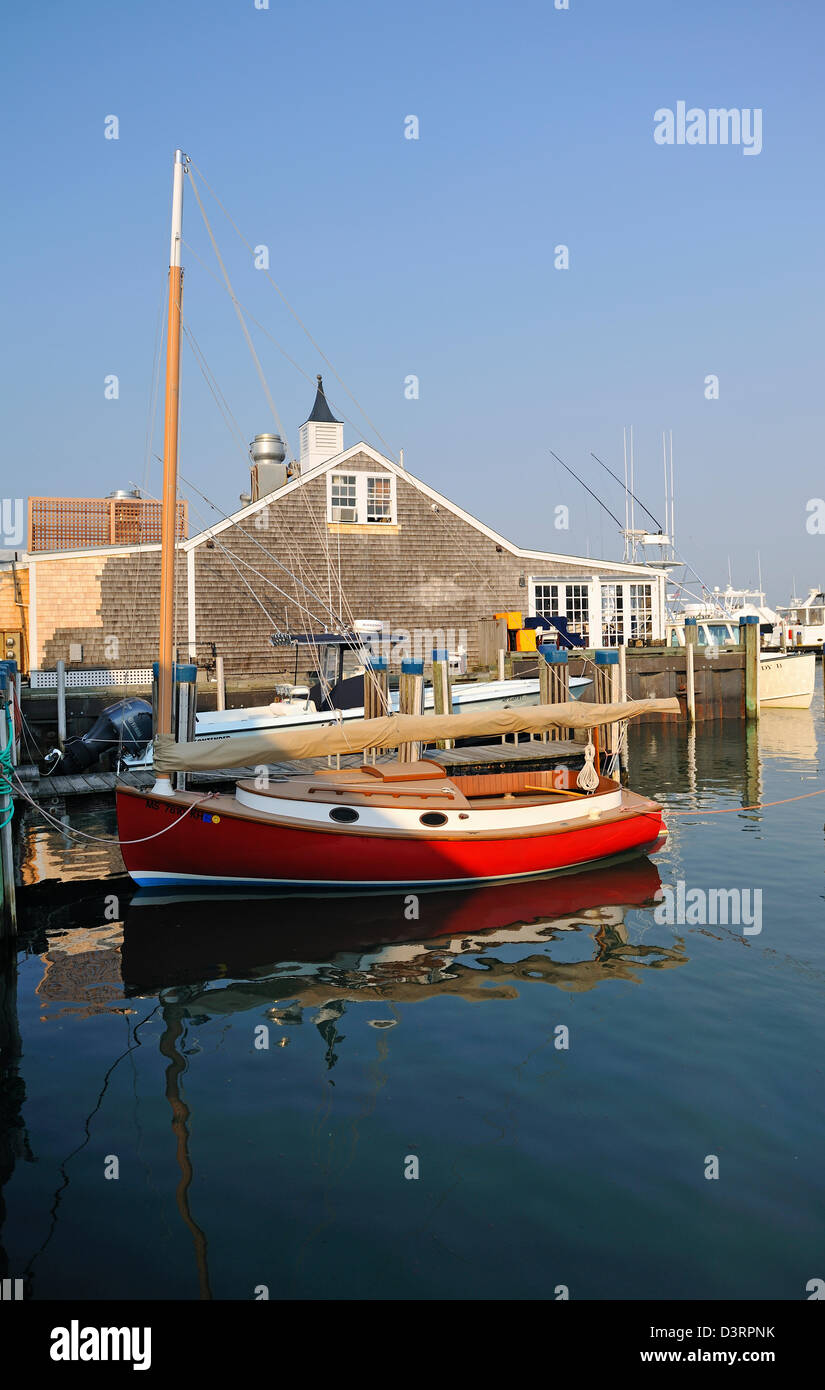 Red wooden sailboat in Nantucket Harbor, Nantucket Island, MA Stock Photo