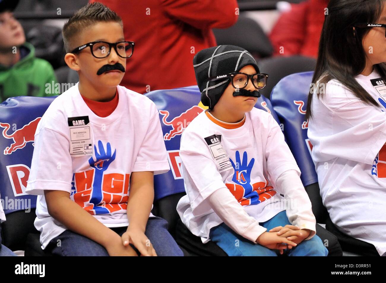 Los Angeles, CA., USA. 23rd Feb, 2013. Two young Clippers fans part of the High Five Kids Clippers club sport glasses and a mustache spoofing Chris Paul's Cliff Paul charecter during the NBA Basketball game between the Utah Jazz and the Los Angeles Clippers at Staples Center in Los Angeles, California. Josh Thompson/Cal Sport Media Stock Photo