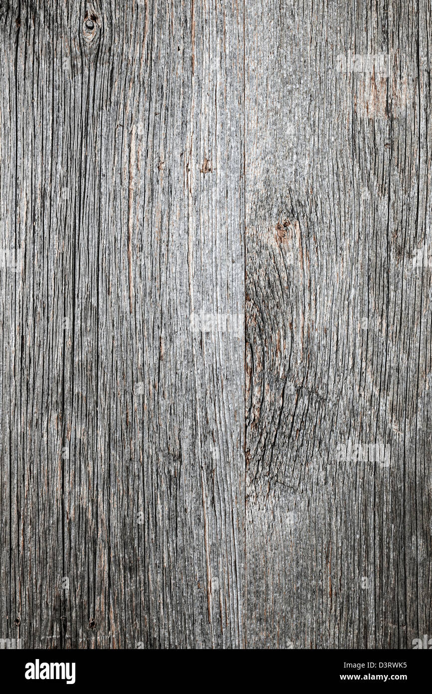 Weathered distressed rustic barn wood as textured background Stock Photo