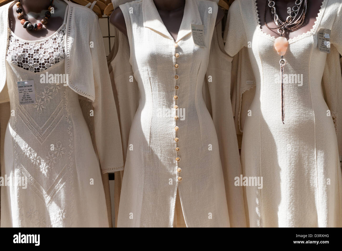 Cream cotton dresses on dark skinned mannequins Puerto de Mogan market, Gran  Canaria Stock Photo - Alamy