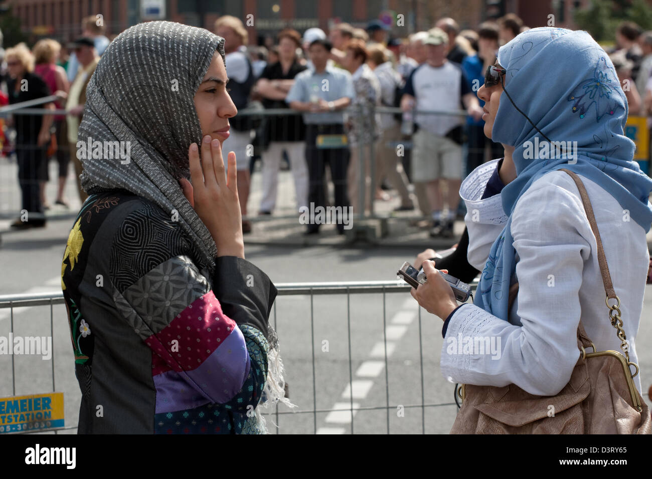 Berlin, Germany, young women wearing headscarves waiting Marathonlaeufer Stock Photo